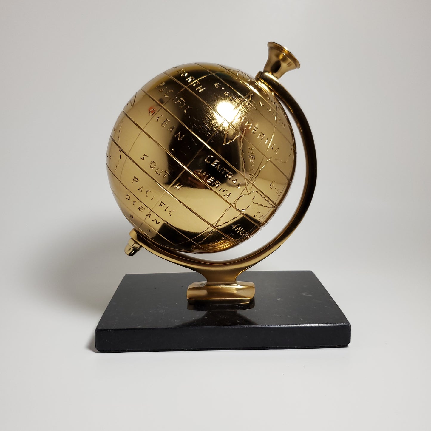 Gold accent globe with black stone base