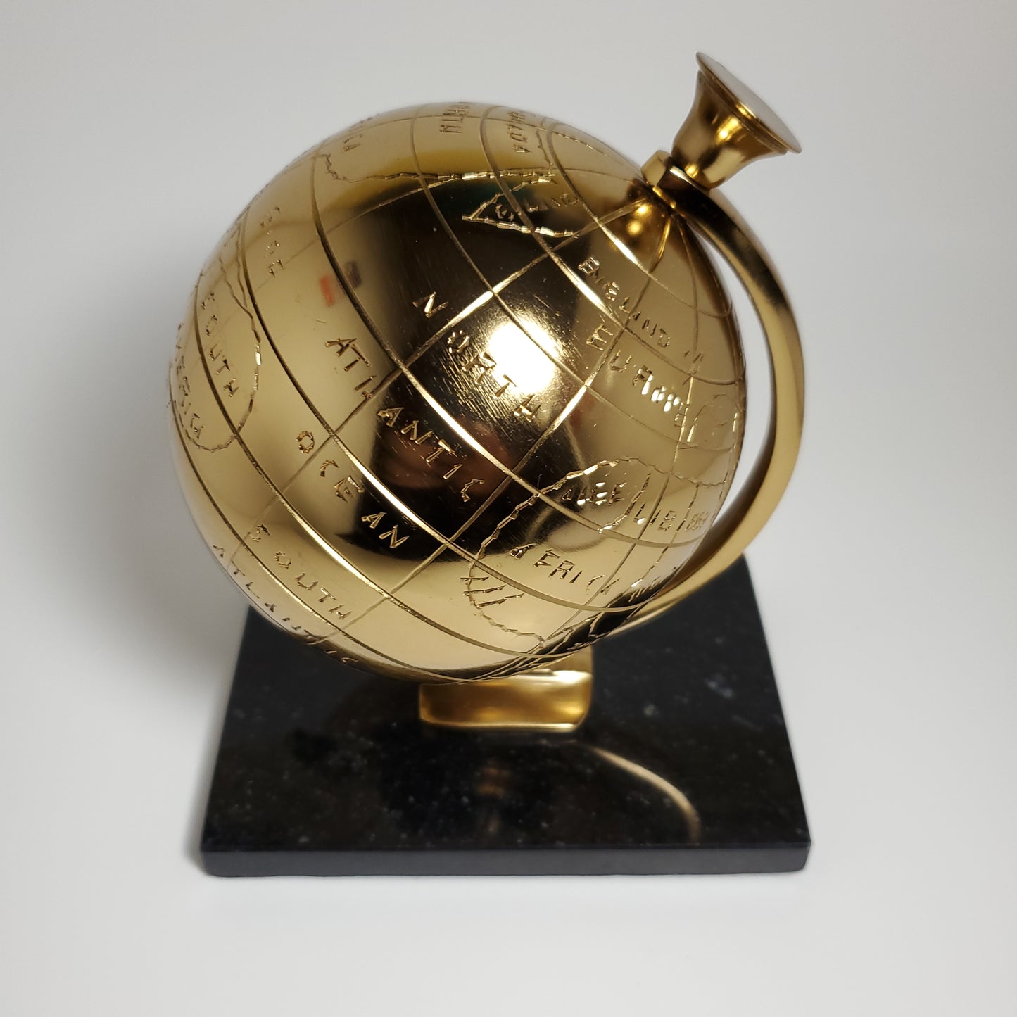 Gold accent globe with black stone base