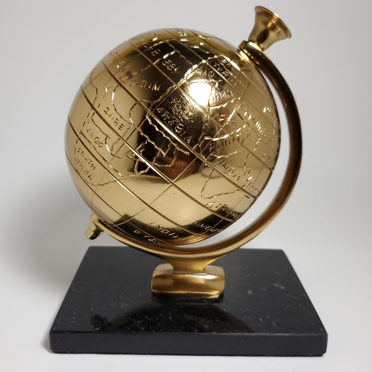 Gold accent globe with black stone base